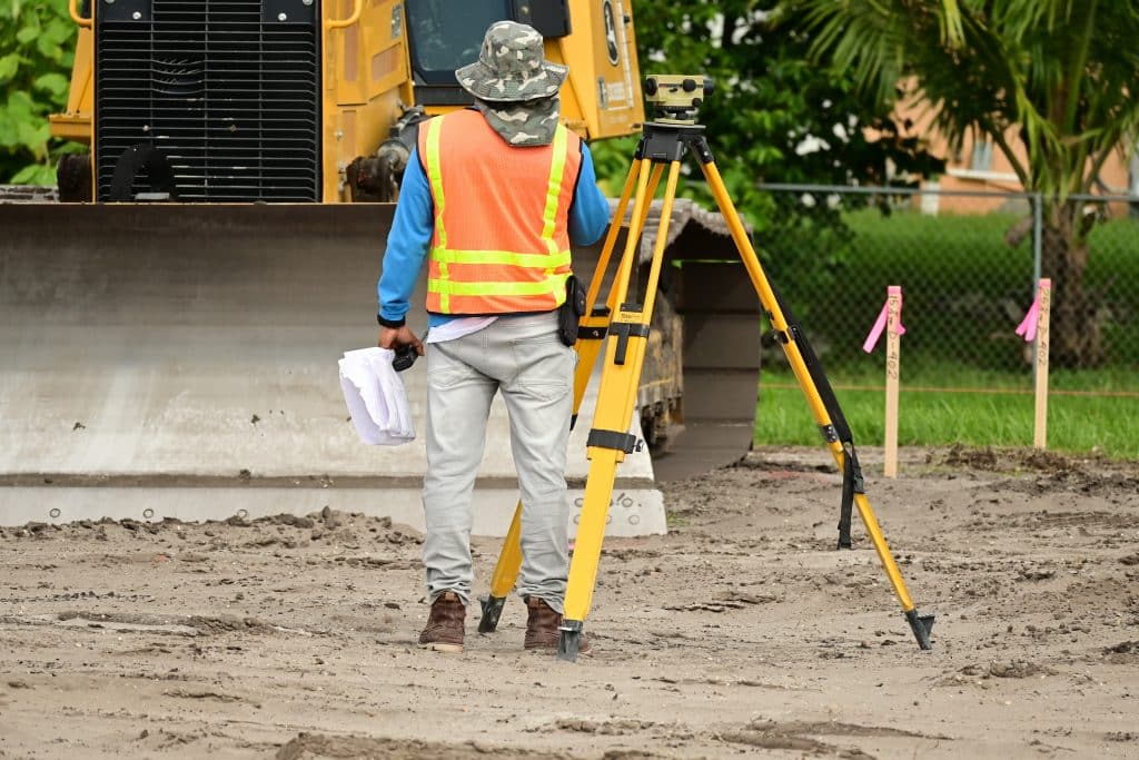 A man performing a commercial real estate land survey