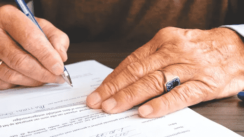 man signing law papers