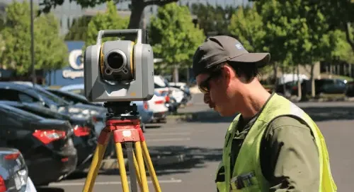 man using survey equipment