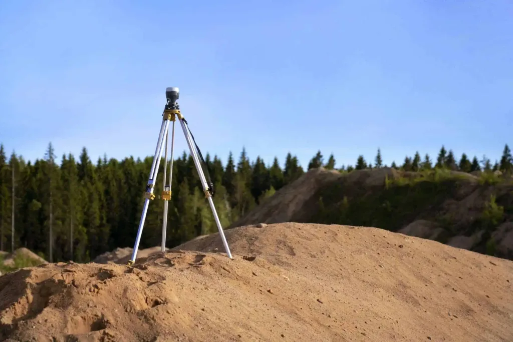 a land survey tripod on a dirt hill