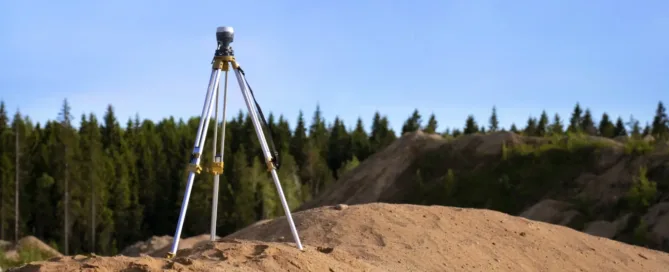 steel tripod on brown hill