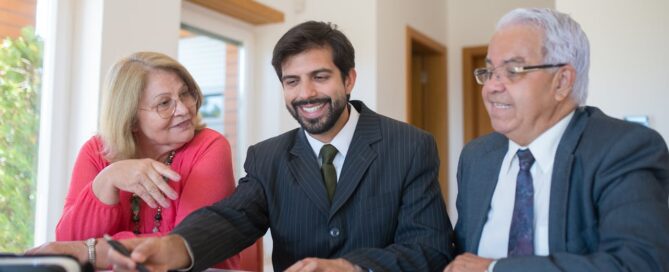 real estate agent talking to a senior couple