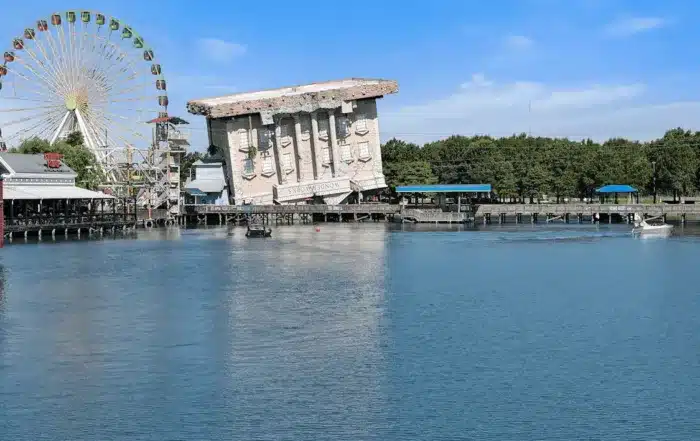 ferris wheel and upside down building by lake in myrtle beach usa
