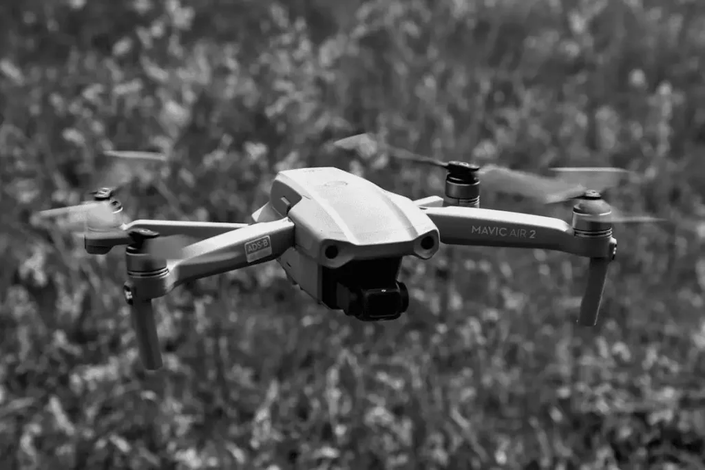 a grayscale of a drone flying