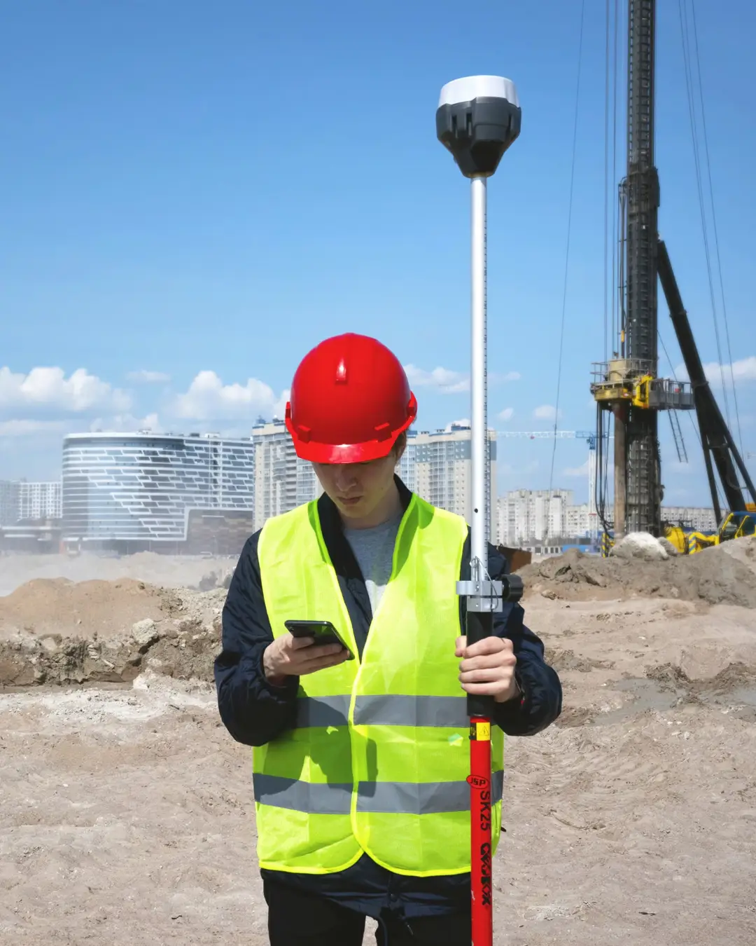 ALTA Land Surveyor ALTA Land Survey being conducted with GPS equipment by professional in high visibility safety clothing.