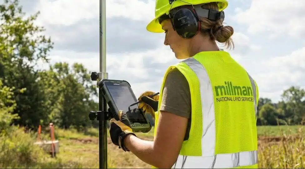commercial land surveyor using GPS equipment to document property boundaries for Oklahoma City development project