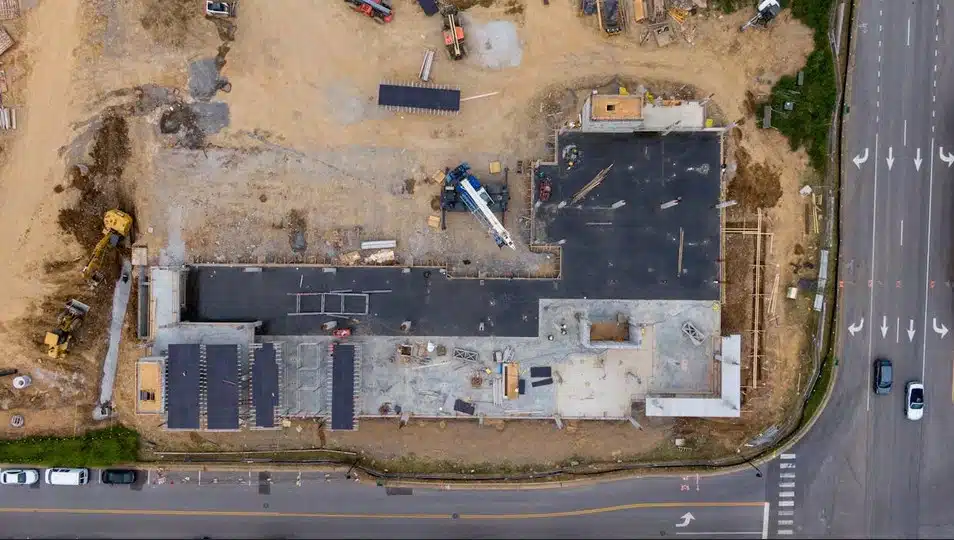 commercial development site in Oklahoma City showing surveyor stakes and construction layout for new retail building
