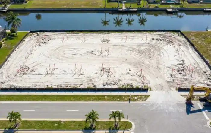 Aerial view of commercial development site in Cape Coral with survey markers and equipment