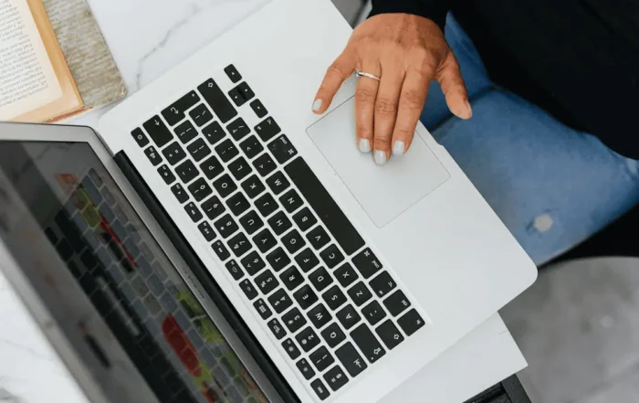 Person Using Macbook on White Table