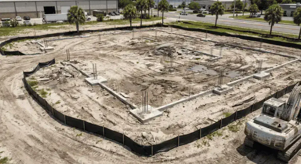A close up of survey markers and staking pins placed on a commercial development site. 